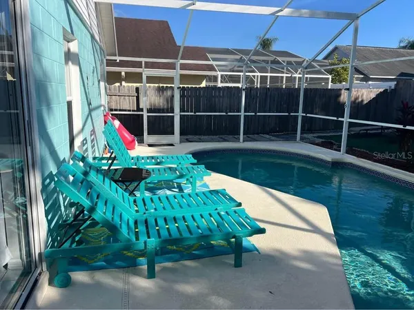 a view of yard with swimming pool and sitting area