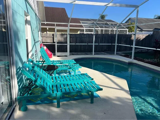 a view of yard with swimming pool and sitting area