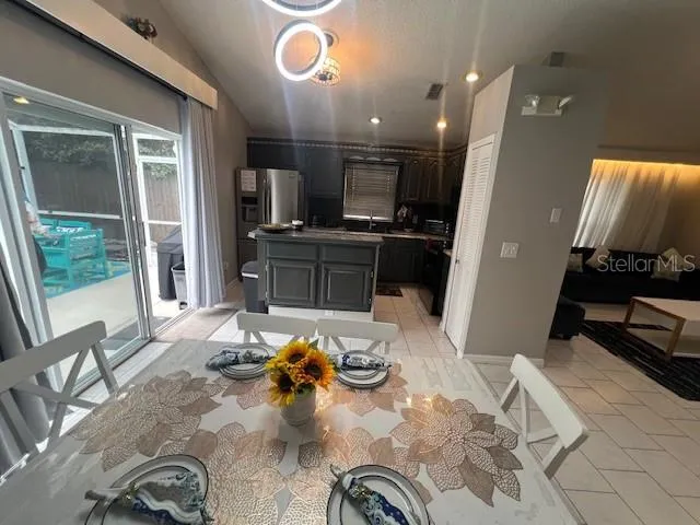 a kitchen with stainless steel appliances kitchen island granite countertop a refrigerator stove top oven and sink