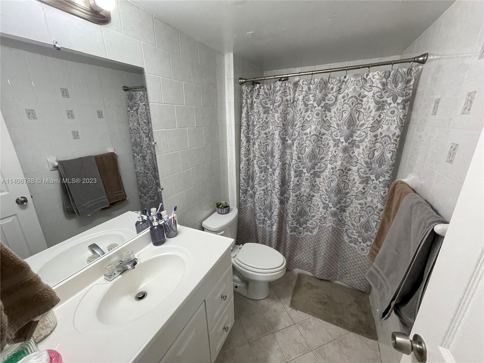 6861 Southwest 147th Avenue, Unit 2G Miami, FL 33193 - Photo 14 of 34 a bathroom with a sink toilet and shower