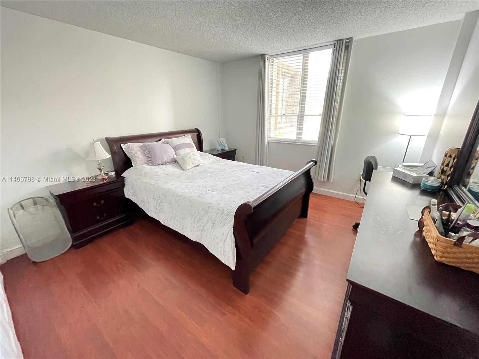 6861 Southwest 147th Avenue, Unit 2G Miami, FL 33193 - Photo 16 of 34 a bed room with a bed and a night stand