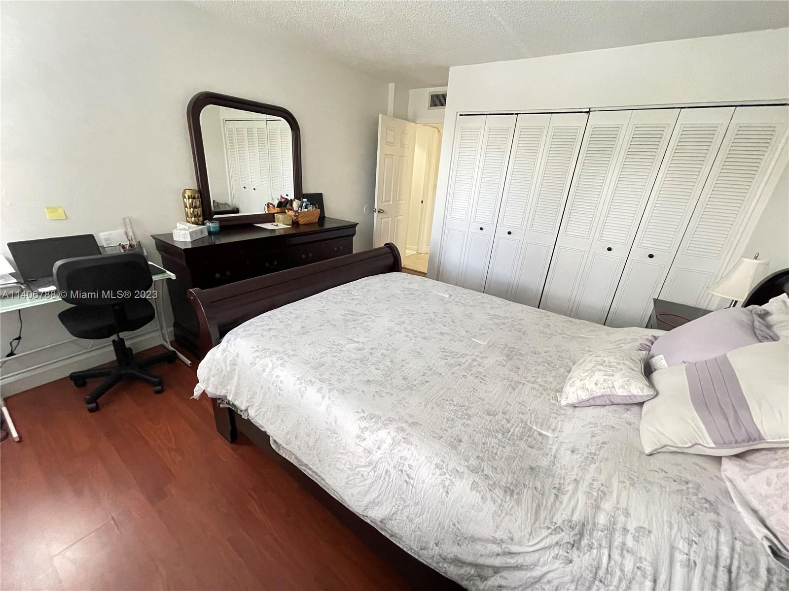 6861 Southwest 147th Avenue, Unit 2G Miami, FL 33193 - Photo 17 of 34 a bedroom with a bed and a mirror
