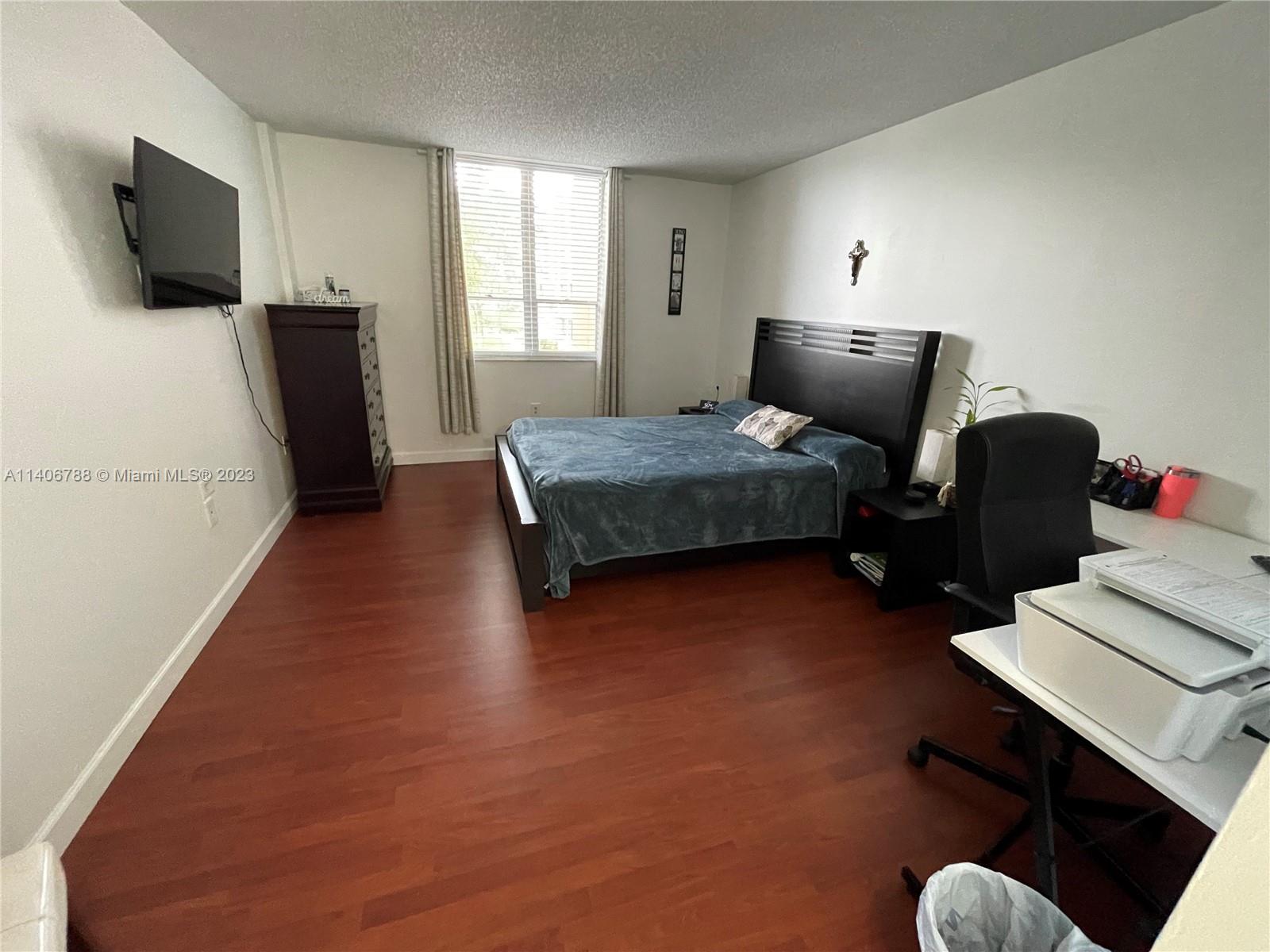6861 Southwest 147th Avenue, Unit 2G Miami, FL 33193 - Photo 18 of 34 a bedroom with bed and flat screen tv