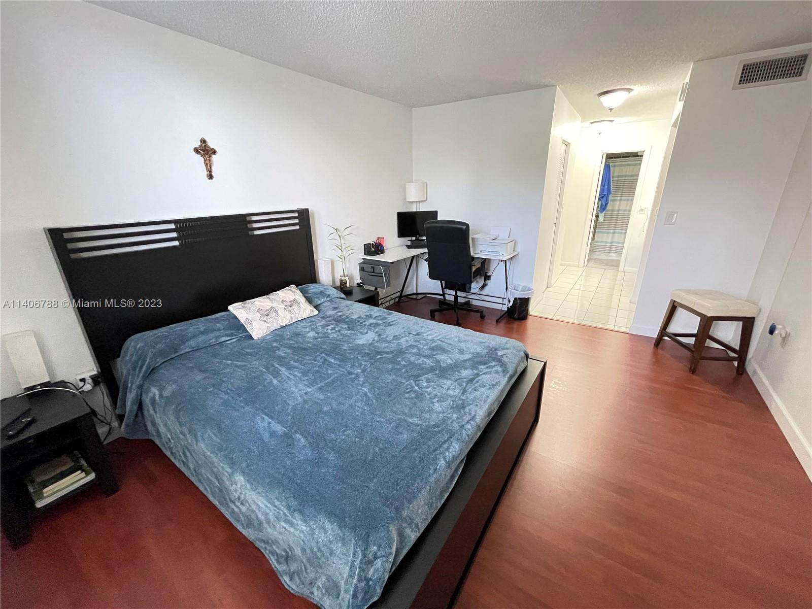 6861 Southwest 147th Avenue, Unit 2G Miami, FL 33193 - Photo 19 of 34 a bed sitting in a room next to a window