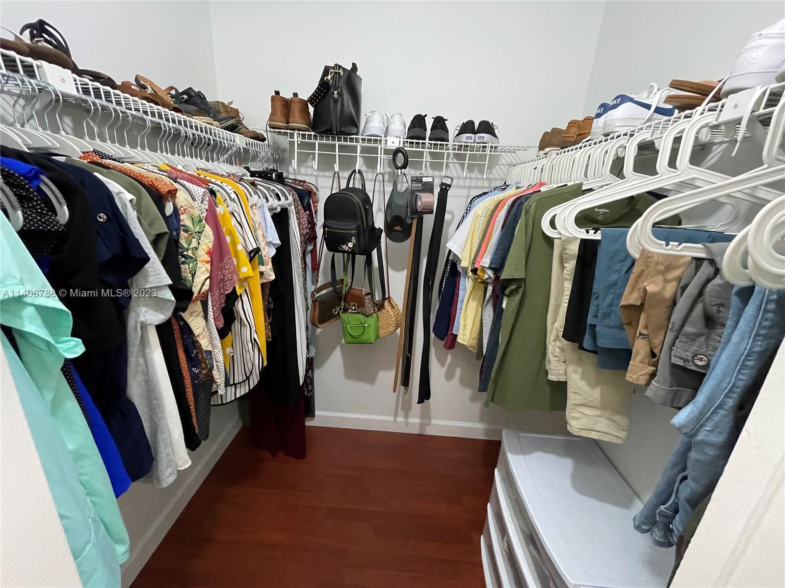 6861 Southwest 147th Avenue, Unit 2G Miami, FL 33193 - Photo 20 of 34 a view of walk in closet with clothes and shoes