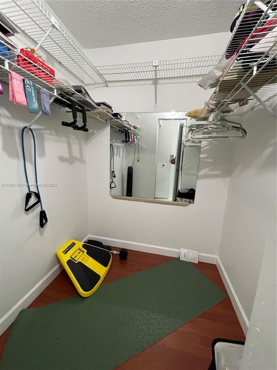 6861 Southwest 147th Avenue, Unit 2G Miami, FL 33193 - Photo 24 of 34 an aerial view of a room with gym equipment