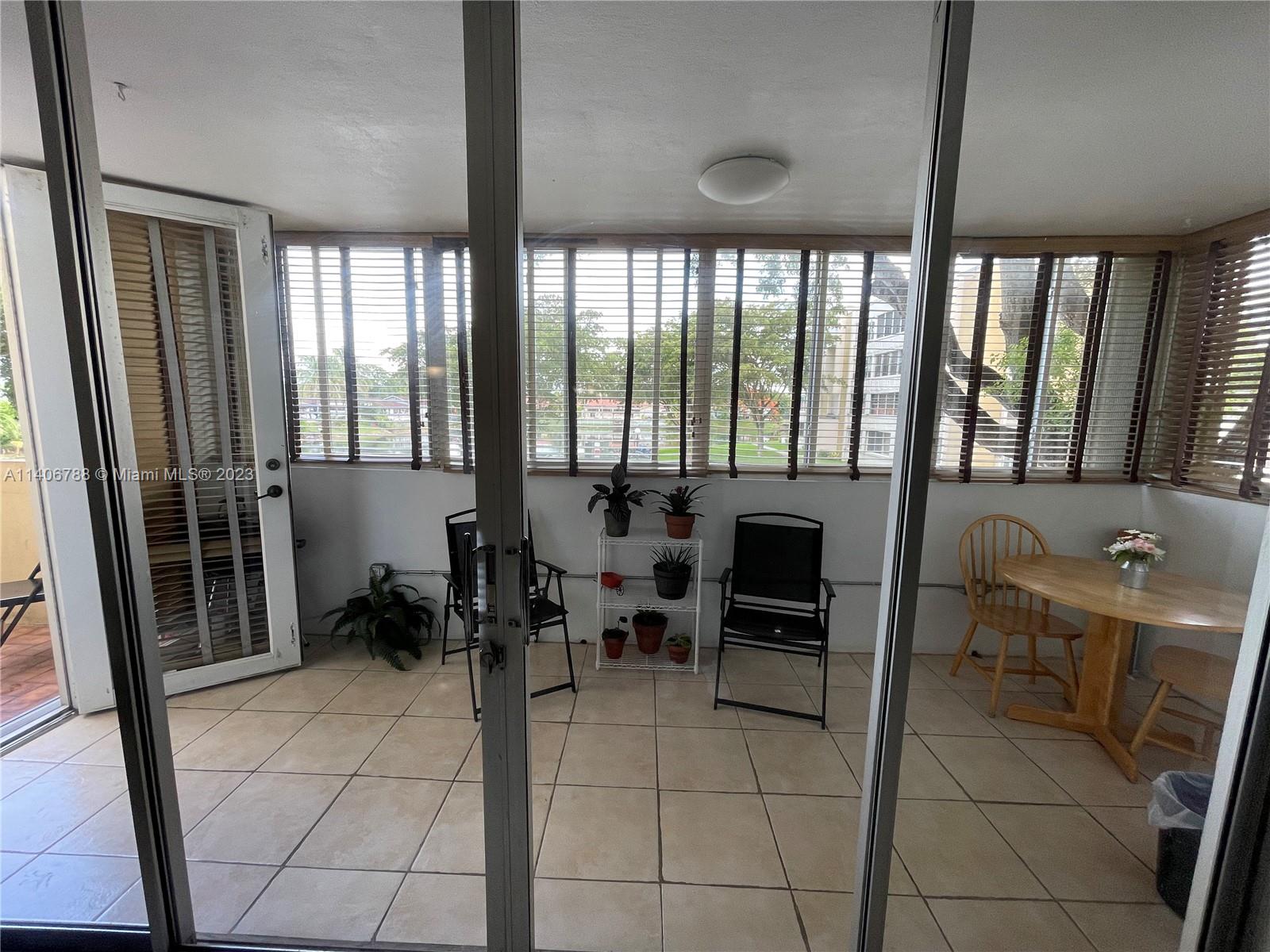 6861 Southwest 147th Avenue, Unit 2G Miami, FL 33193 - Photo 26 of 34 a lobby with furniture and floor to ceiling window
