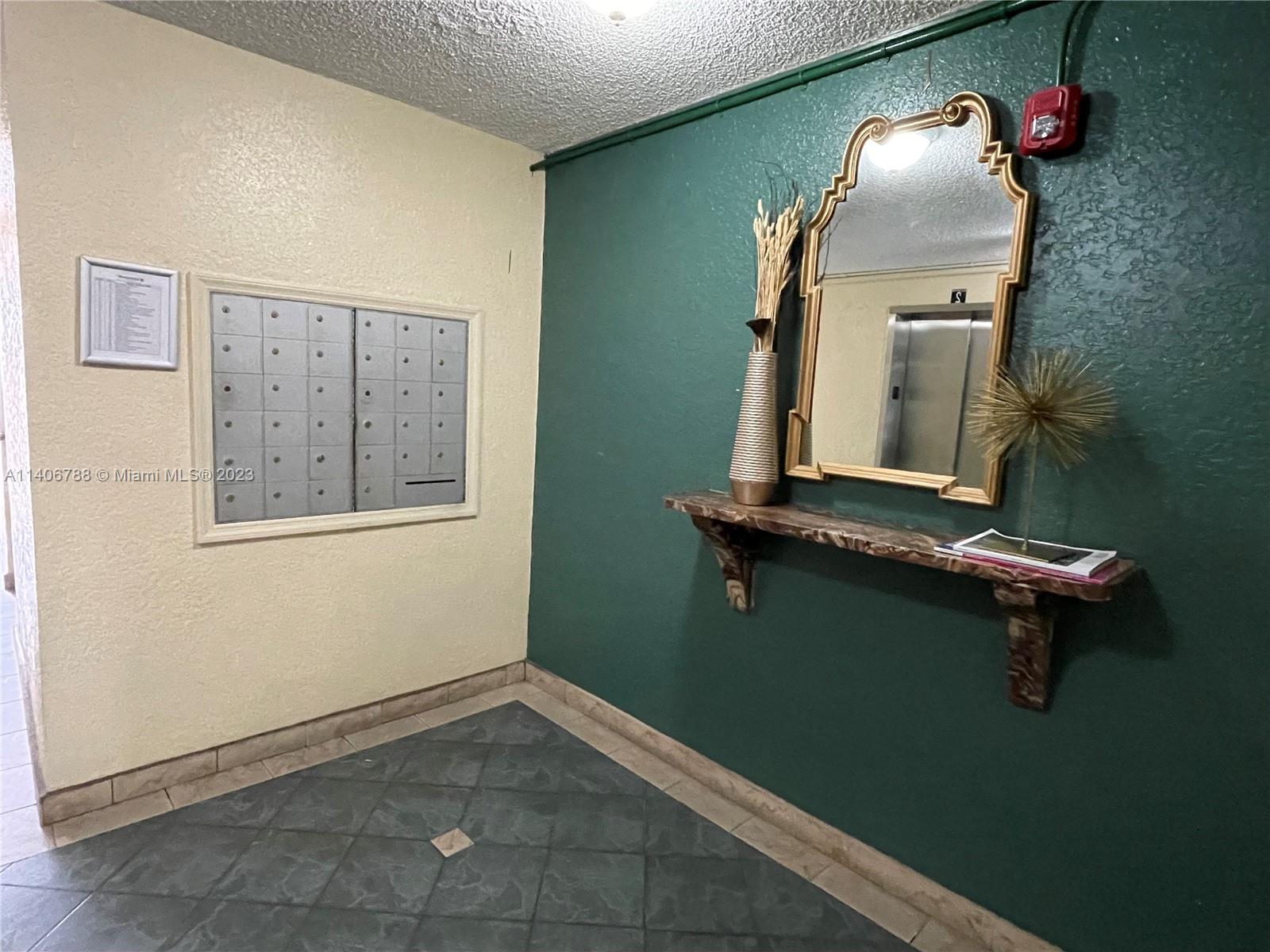 6861 Southwest 147th Avenue, Unit 2G Miami, FL 33193 - Photo 33 of 34 a room with a mirror and a fan