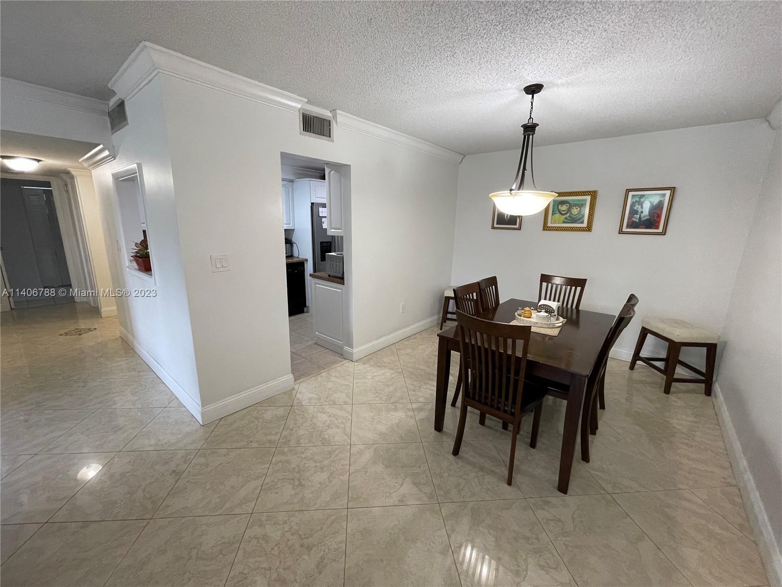 6861 Southwest 147th Avenue, Unit 2G Miami, FL 33193 - Photo 7 of 34 a view of a dining room with furniture
