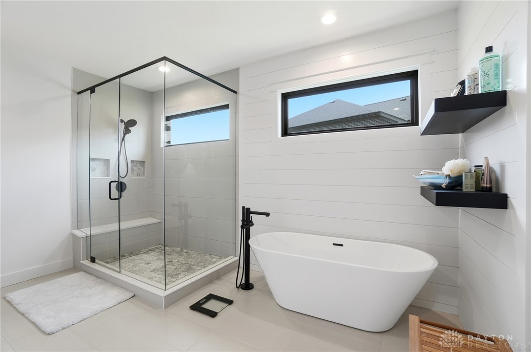 1247 Normandy Rue Dayton, OH 45458 - Photo 24 of 76 This sleek bathroom features a spacious walk-in shower and a freestanding soaking tub.