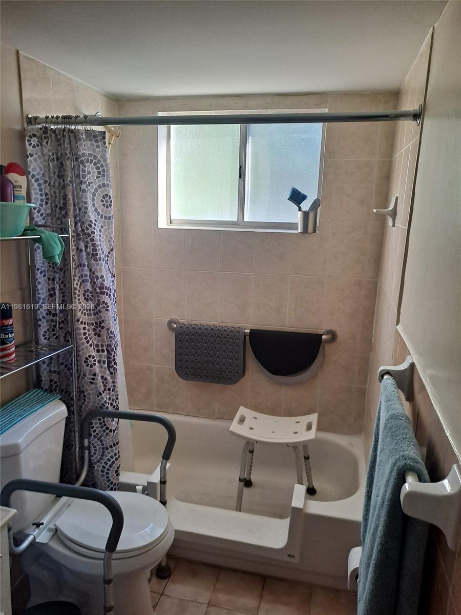 10765 Southwest 4th Street, Unit 1 Sweetwater, FL 33174 - Photo 5 of 6 a bathroom with a sink toilet and shower