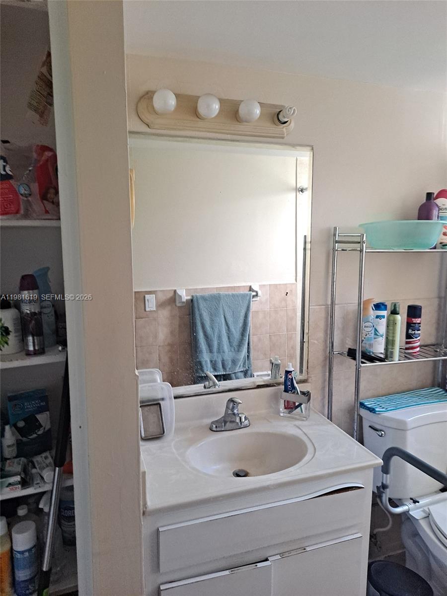 10765 Southwest 4th Street, Unit 1 Sweetwater, FL 33174 - Photo 6 of 6 a bathroom with a sink and a mirror