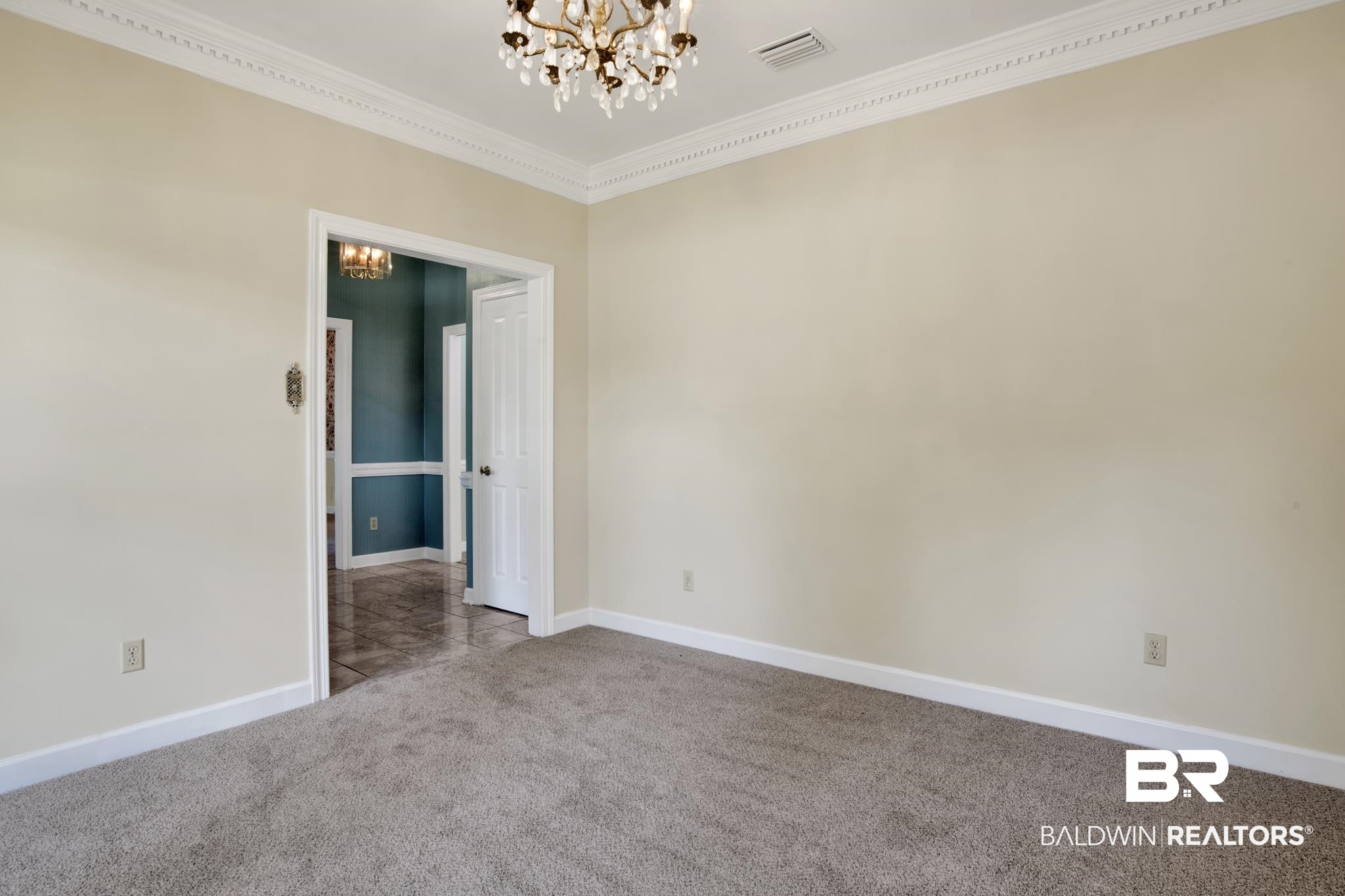 6805 Hunters Court Mobile, AL 36695 - Photo 6 of 37 Spare room with a chandelier, carpet floors, ornamental molding, and baseboards