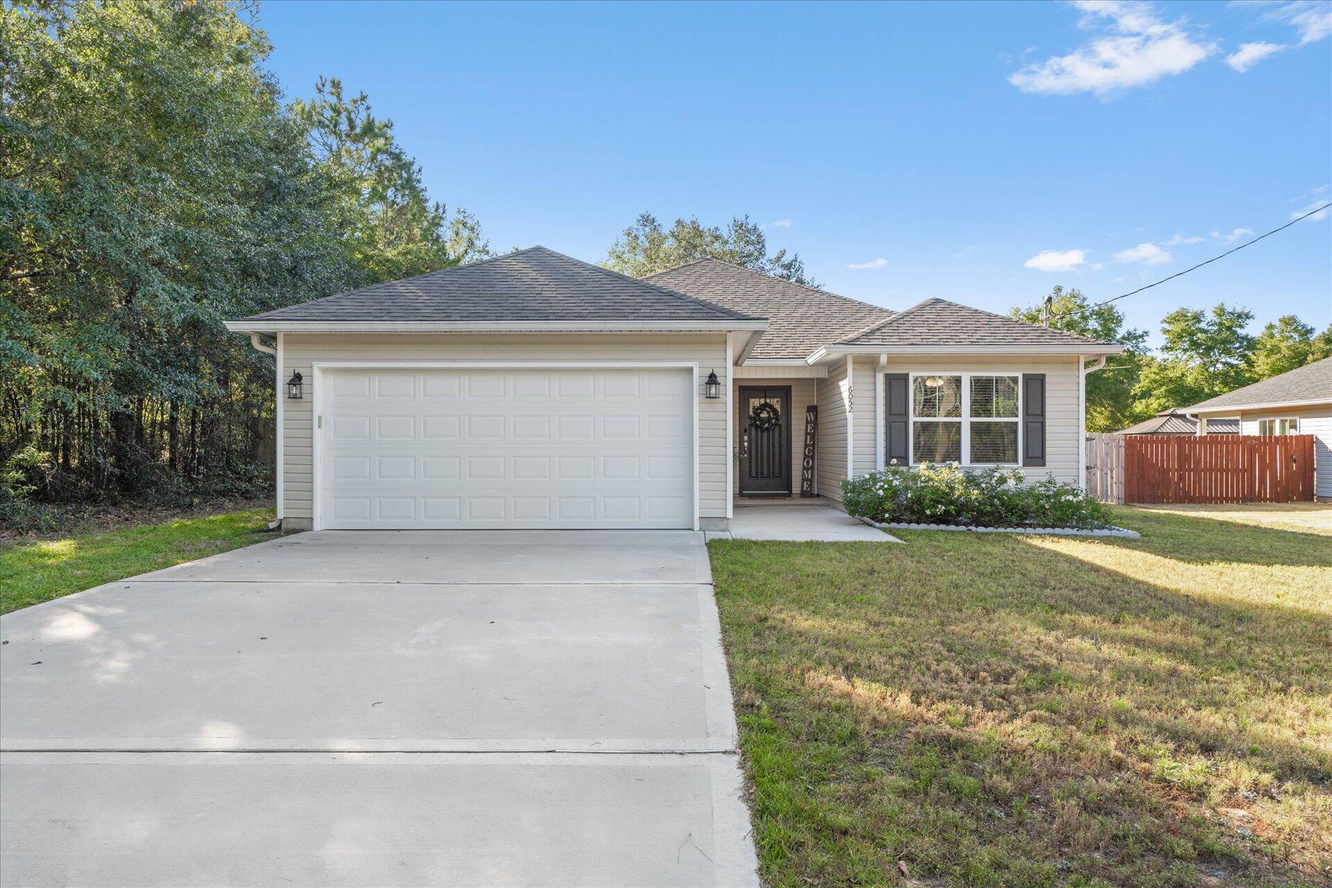 6052 Eden Road Crestview, FL 32539 - Photo 1 of 42 a front view of a house with a yard and garage