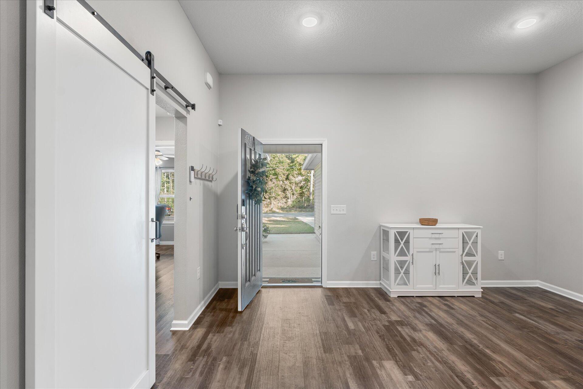 6052 Eden Road Crestview, FL 32539 - Photo 15 of 42 an empty room with wooden floor and windows