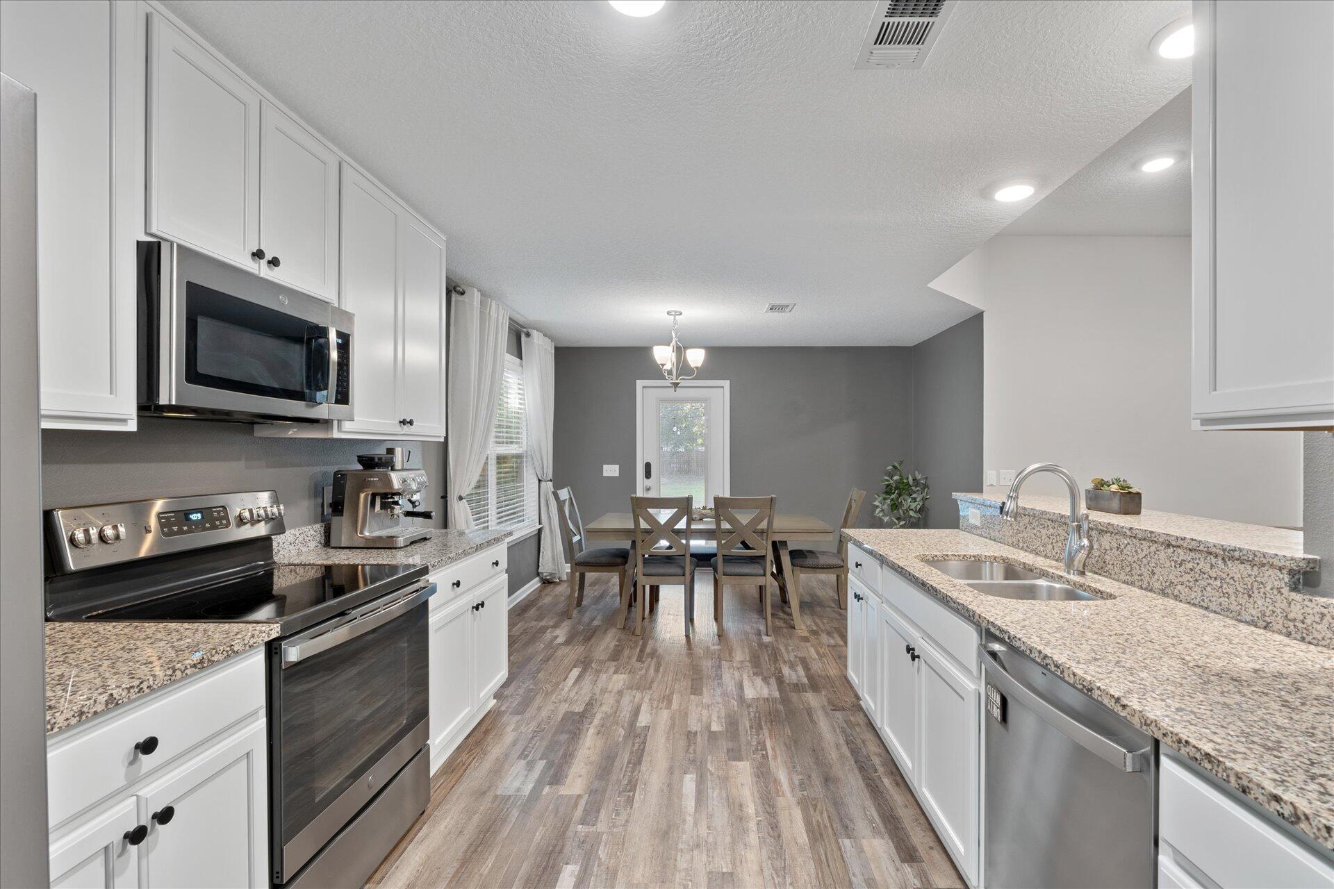 6052 Eden Road Crestview, FL 32539 - Photo 17 of 42 a kitchen with a sink stove and microwave