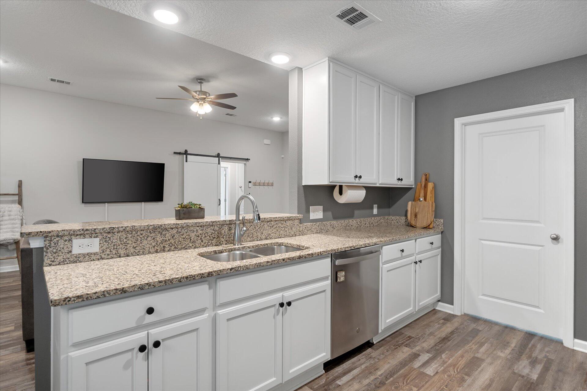 6052 Eden Road Crestview, FL 32539 - Photo 20 of 42 a view with double vanity sink a mirror and a refrigerator