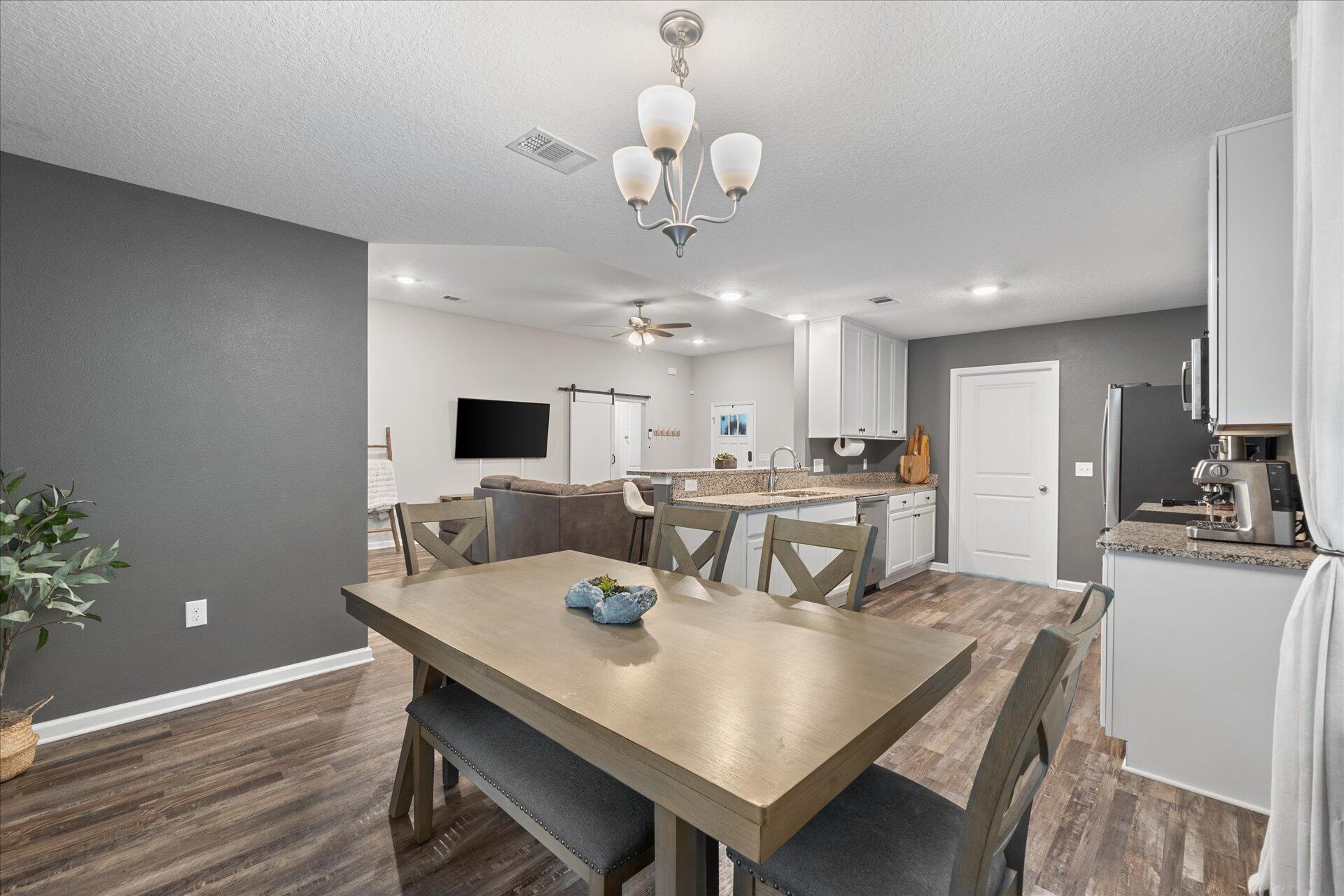 6052 Eden Road Crestview, FL 32539 - Photo 21 of 42 a view of a dining room with furniture and wooden floor
