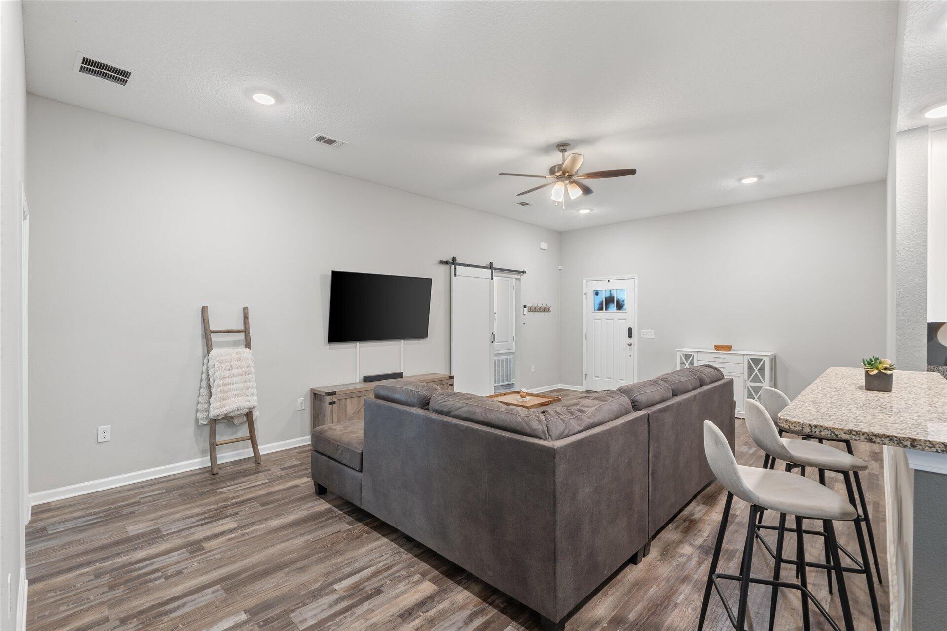 6052 Eden Road Crestview, FL 32539 - Photo 25 of 42 a living room with furniture and a flat screen tv
