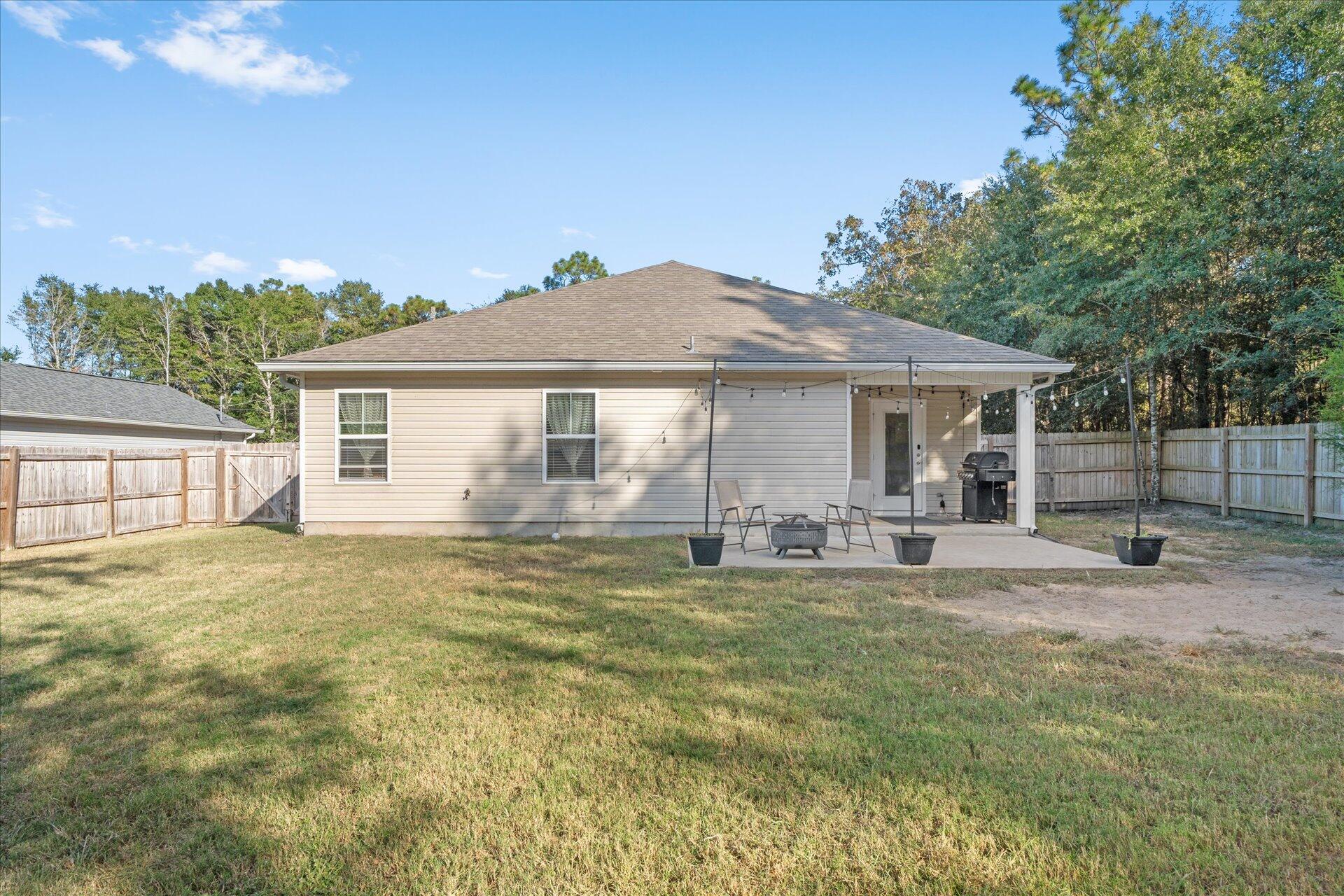6052 Eden Road Crestview, FL 32539 - Photo 31 of 42 a front view of a house with a garden and patio