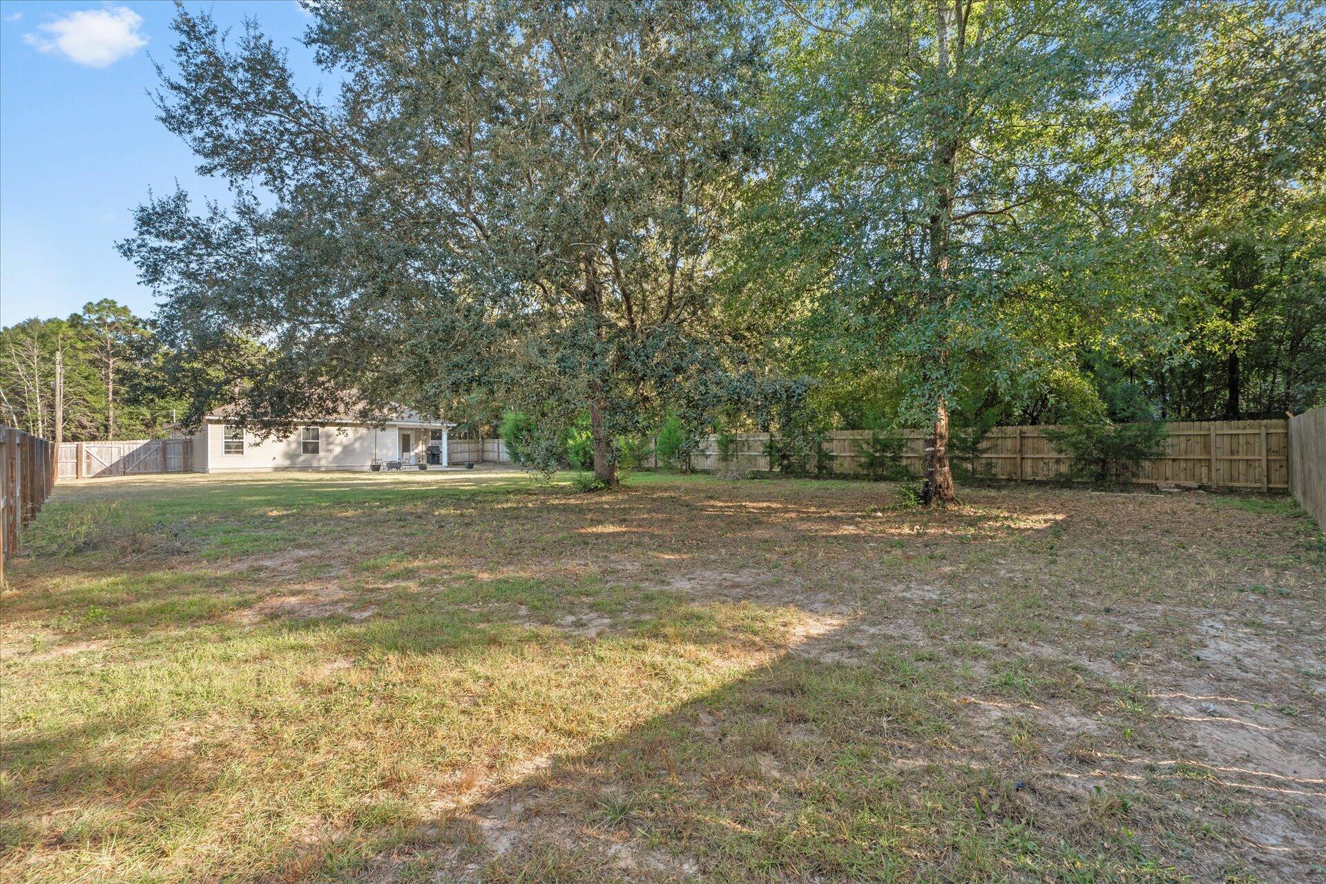 6052 Eden Road Crestview, FL 32539 - Photo 32 of 42 a view of outdoor space with deck and yard