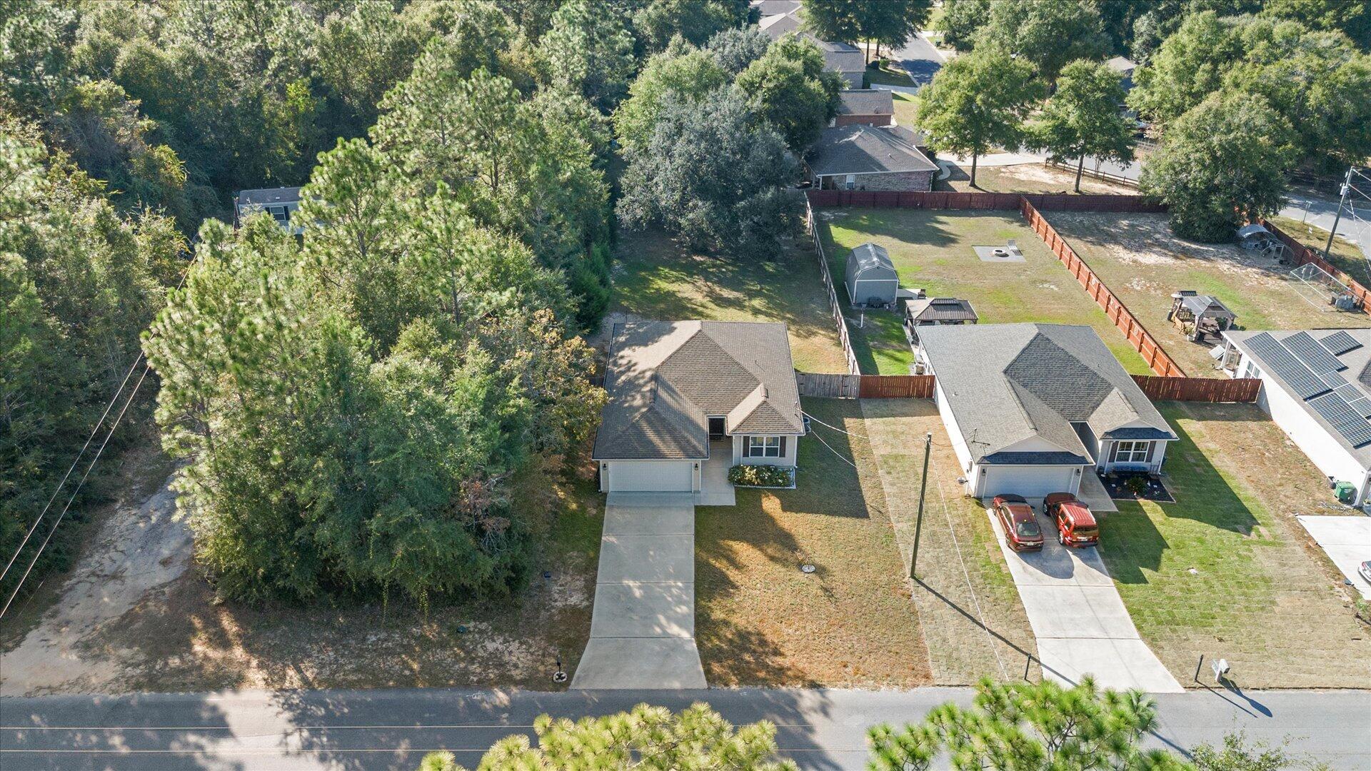 6052 Eden Road Crestview, FL 32539 - Photo 34 of 42 an aerial view of residential houses with outdoor space
