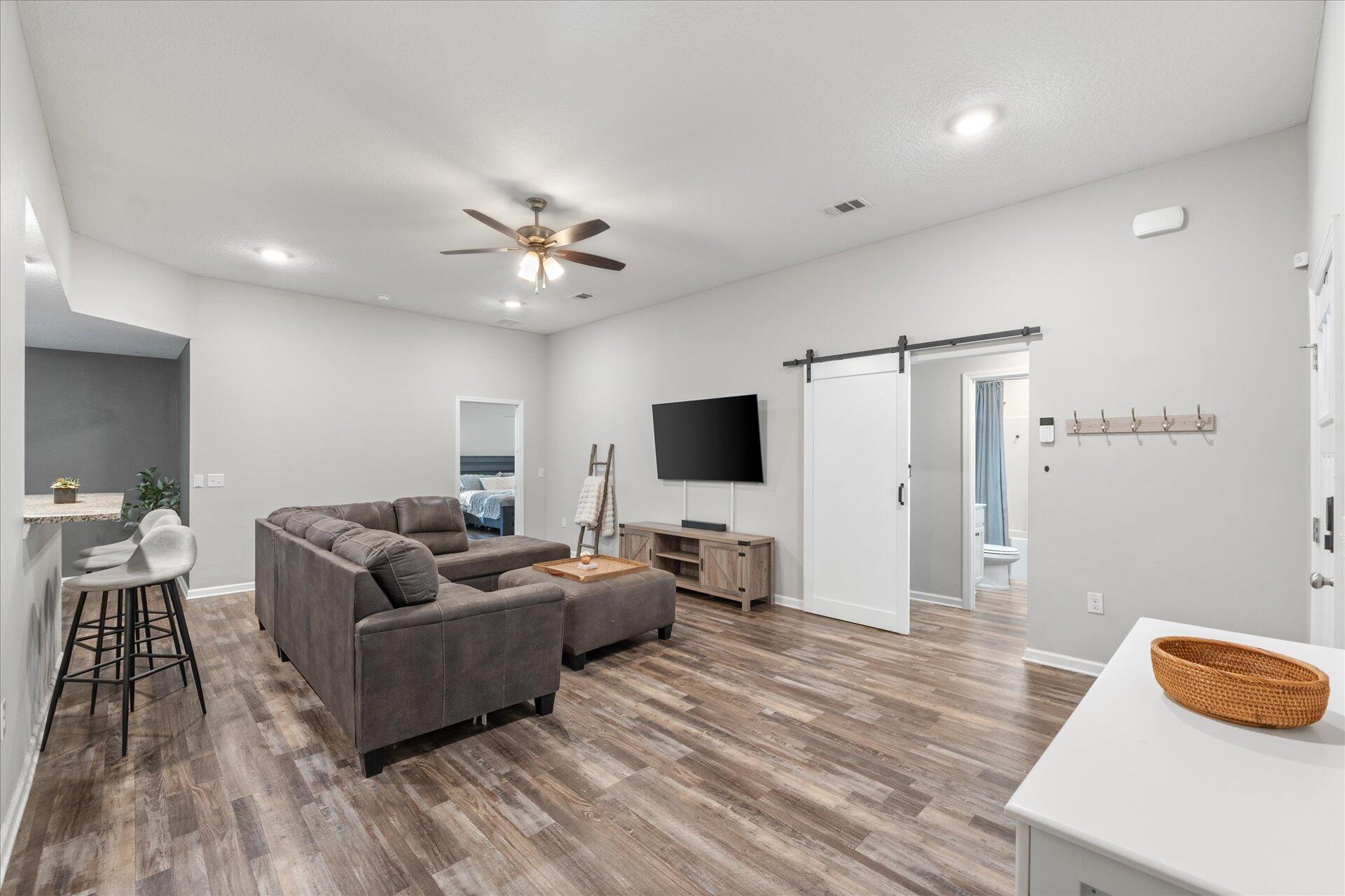 6052 Eden Road Crestview, FL 32539 - Photo 37 of 42 a living room with furniture and a flat screen tv