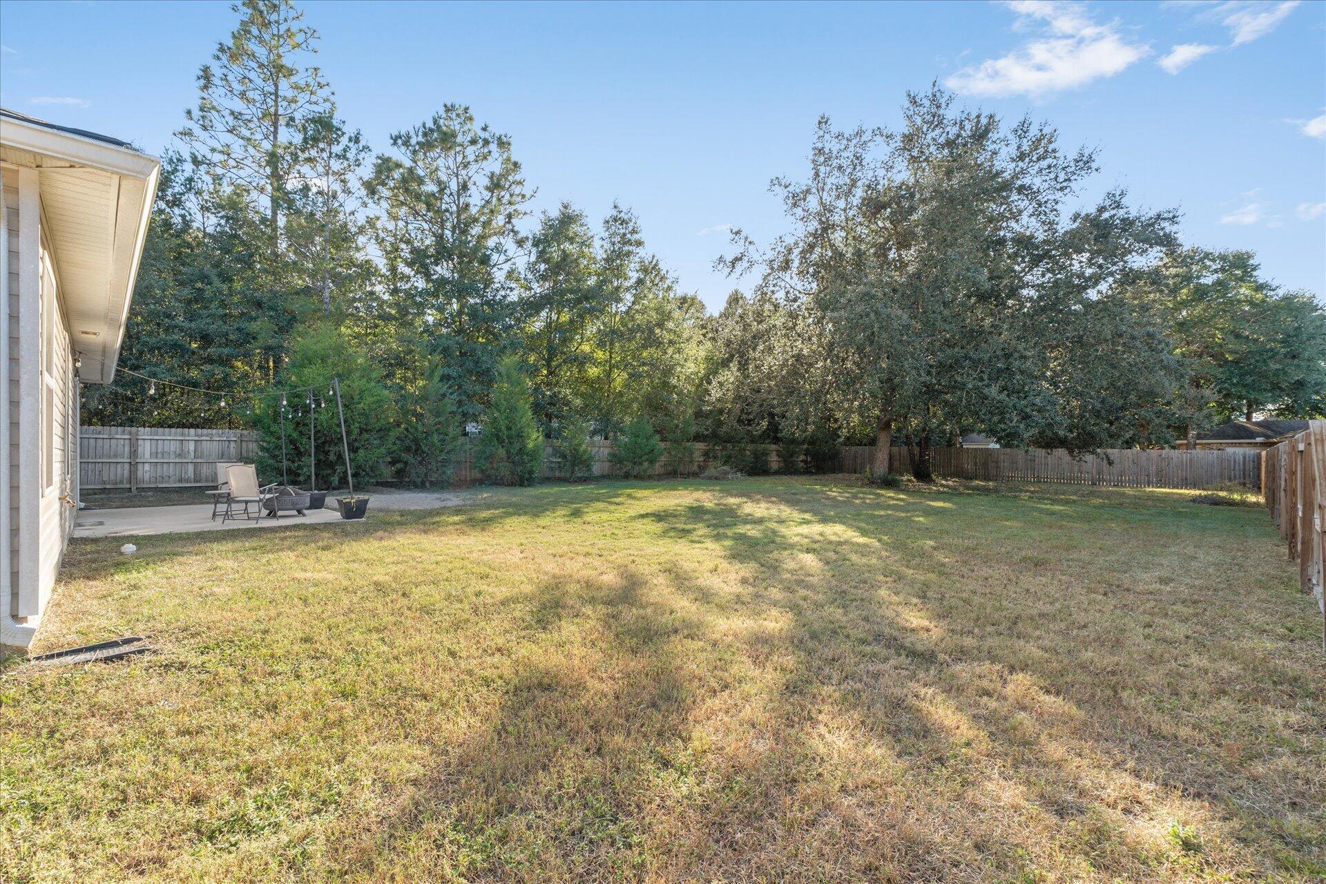 6052 Eden Road Crestview, FL 32539 - Photo 38 of 42 a view of backyard with swimming pool and seating space