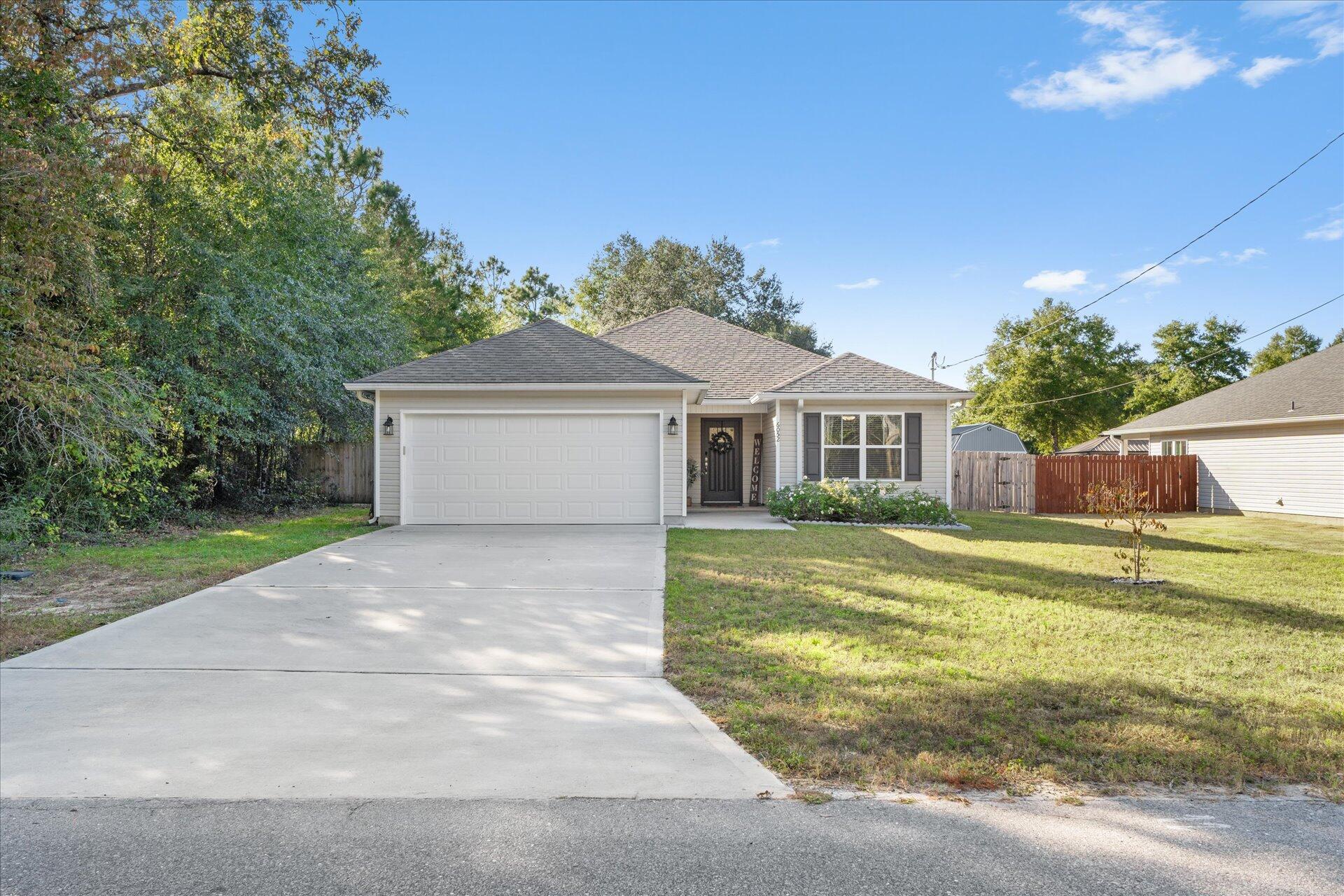 6052 Eden Road Crestview, FL 32539 - Photo 39 of 42 a front view of a house with a yard and garage
