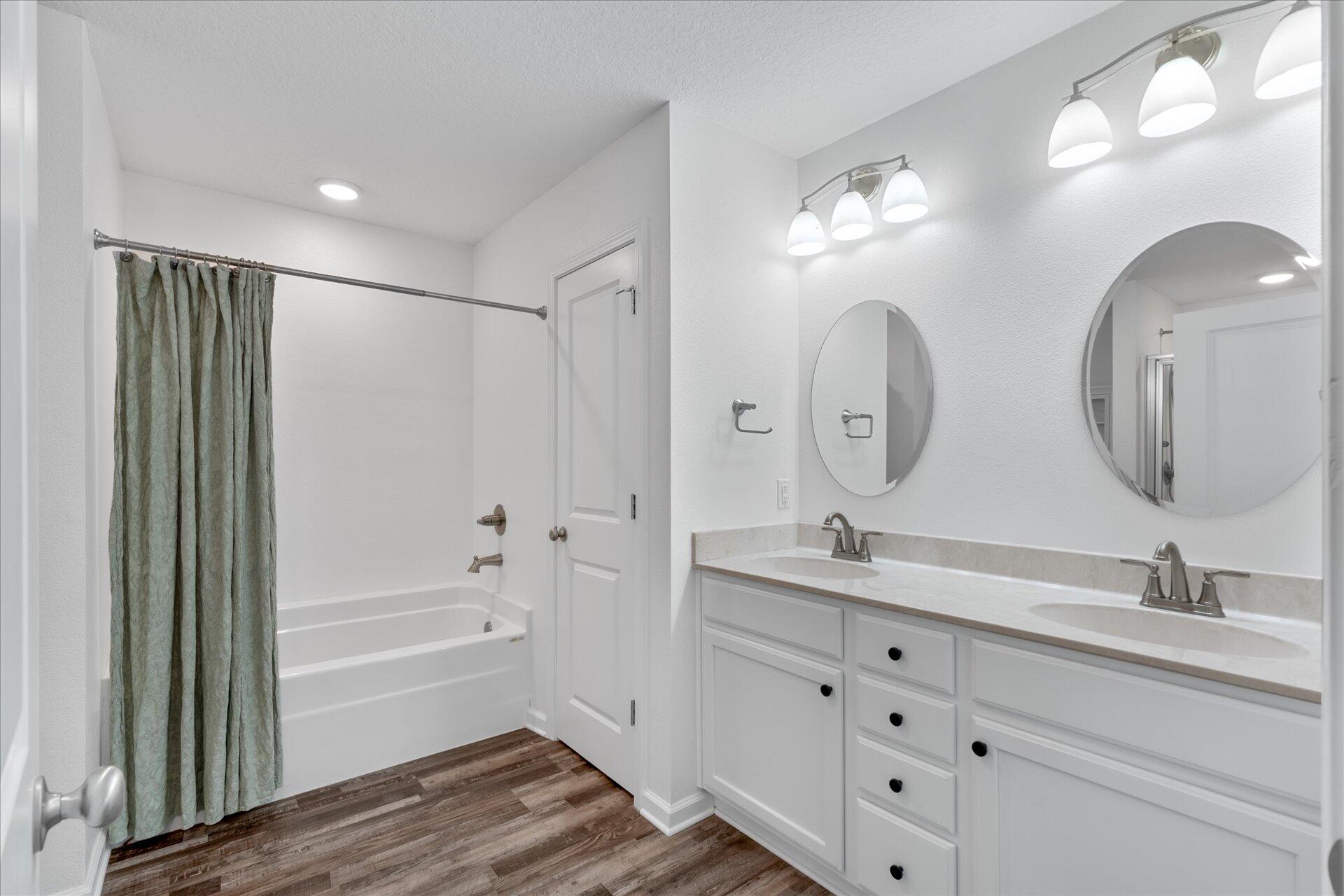 6052 Eden Road Crestview, FL 32539 - Photo 6 of 42 a bathroom with double vanity sinks a large mirror and a shower