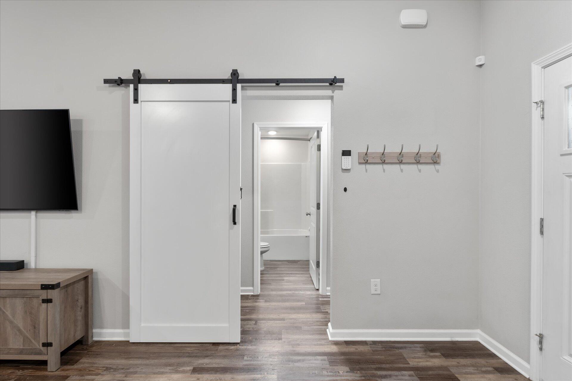 6052 Eden Road Crestview, FL 32539 - Photo 8 of 42 a view of a room with wooden floor and bathroom view