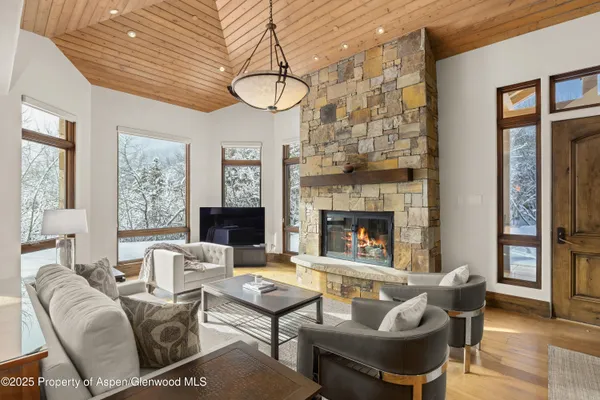 a living room with furniture a fireplace and a table