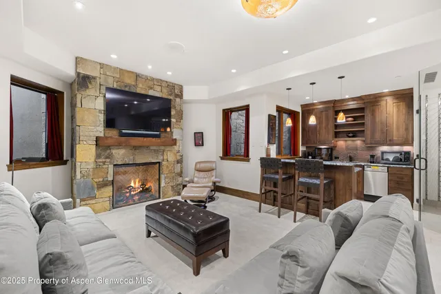 a living room with furniture fireplace and flat screen tv