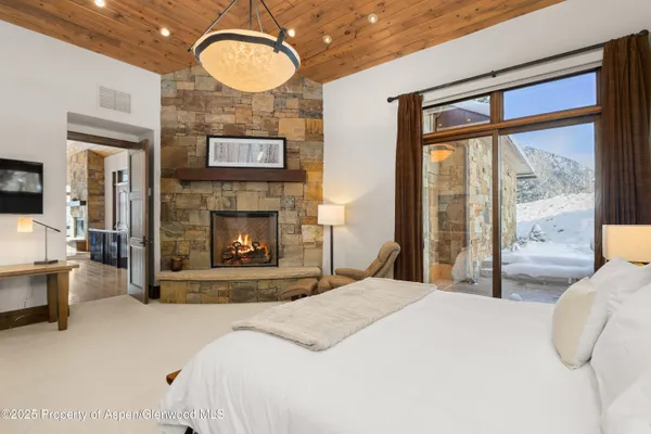 a bedroom with a bed mirror and a large window