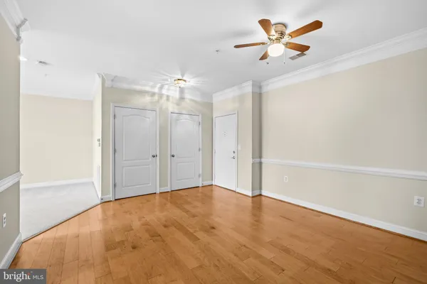 a view of a chandelier fan and hardwood floor