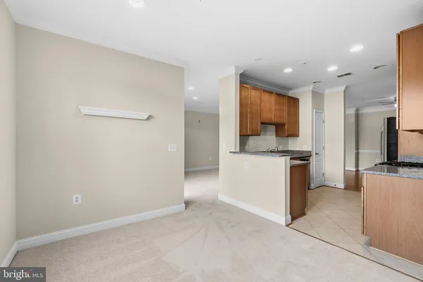 a kitchen with a refrigerator and a stove top oven