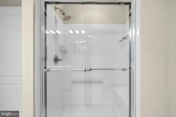 a bathroom with a glass shower door