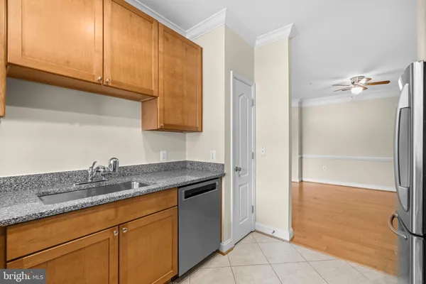 a kitchen with stainless steel appliances granite countertop a sink and cabinets