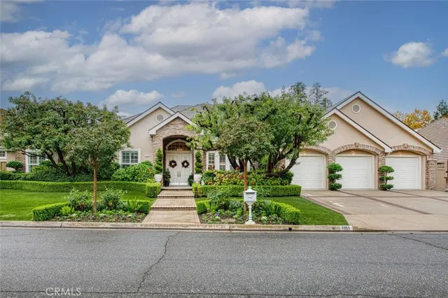 a front view of a house with a yard and a garage