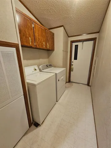 a bathroom with a granite countertop sink a toilet and shower