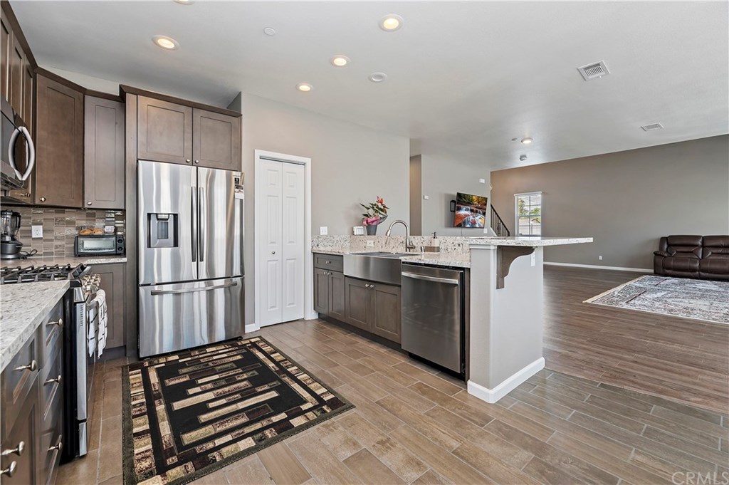 3591 Tyco Drive Riverside, CA 92501 - Photo 11 of 30 a kitchen with stainless steel appliances a refrigerator stove and sink