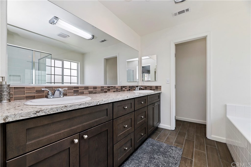 3591 Tyco Drive Riverside, CA 92501 - Photo 21 of 30 a bathroom with a granite countertop double vanity sink and mirror