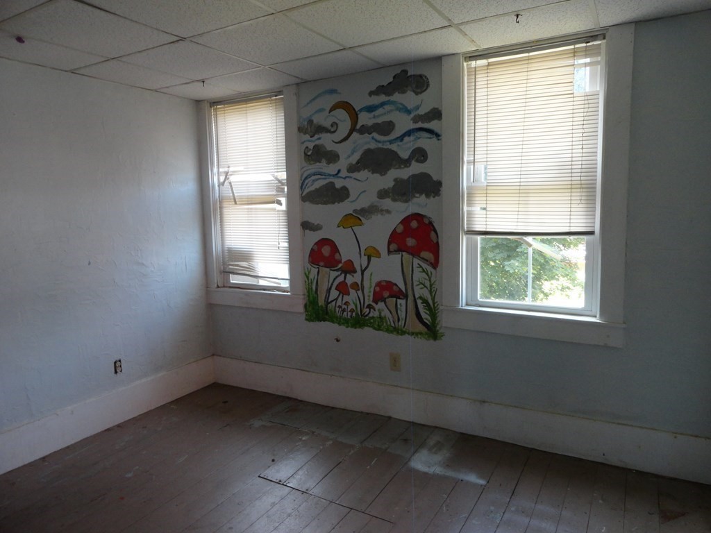 258 Main Street Townsend, MA 01469 - Photo 13 of 23 an empty room with windows and entrance