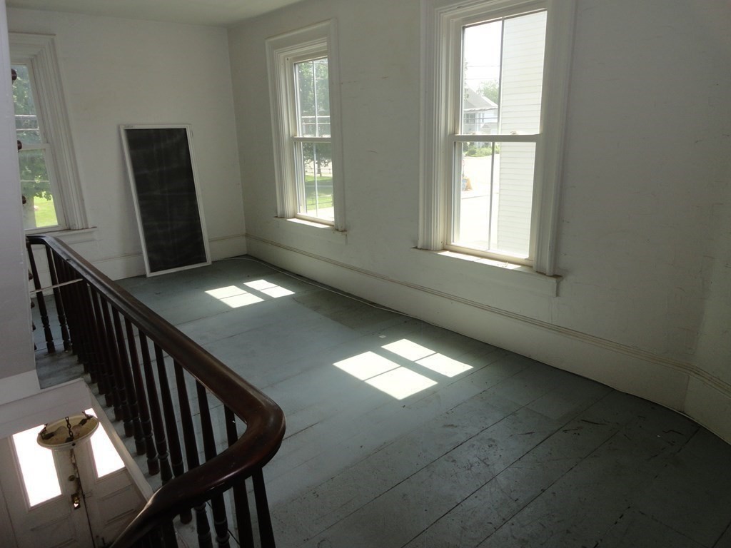 258 Main Street Townsend, MA 01469 - Photo 15 of 23 a view of an empty room with wooden floor and a window