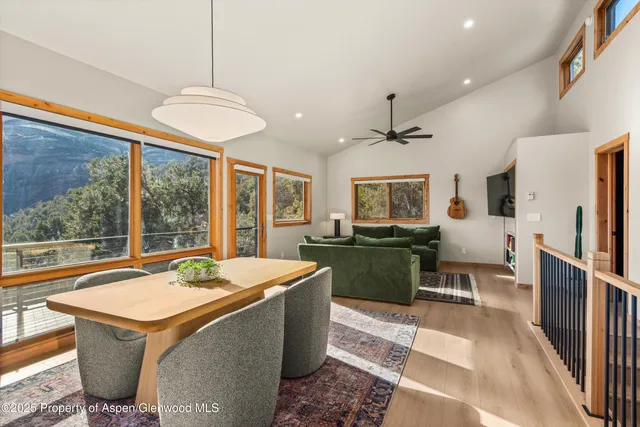 a room with stainless steel appliances kitchen island granite countertop furniture and a chandelier
