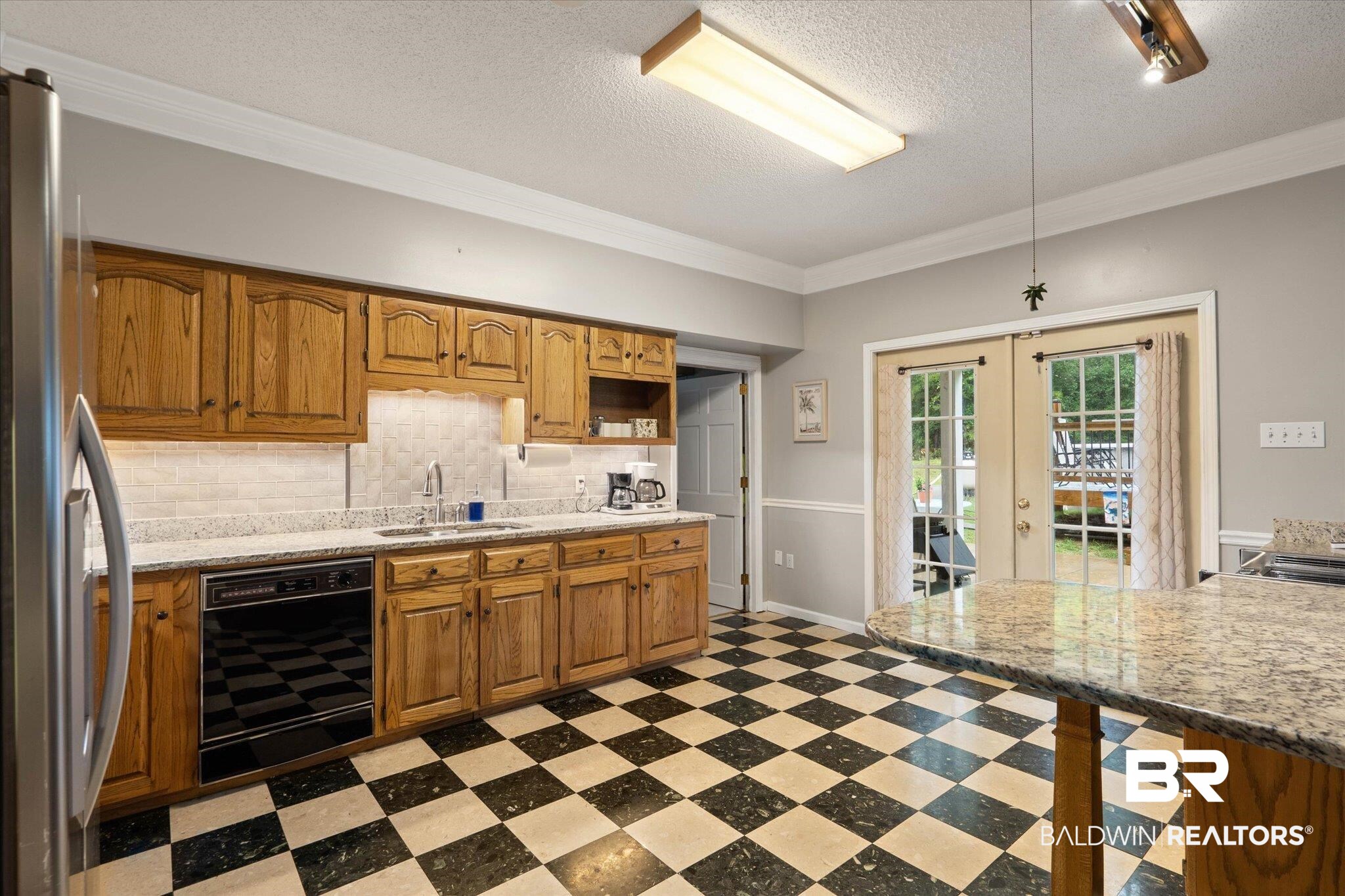 2300 Radcliff Road Saraland, AL 36571 - Photo 6 of 56 Kitchen with dishwasher, french doors, light floors, freestanding refrigerator, and decorative backsplash