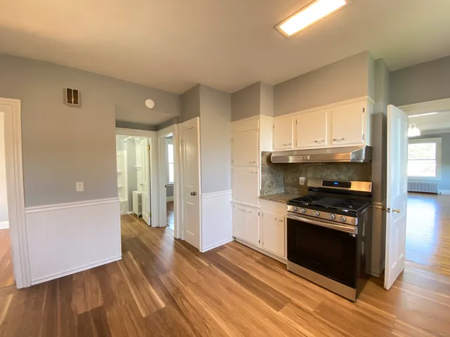 a kitchen with granite countertop a stove and a refrigerator