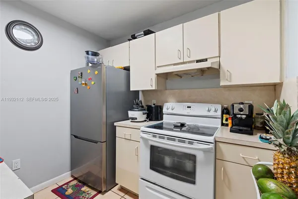 a kitchen with refrigerator and cabinets