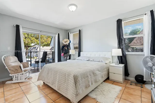 a bedroom with a bed and glass windows