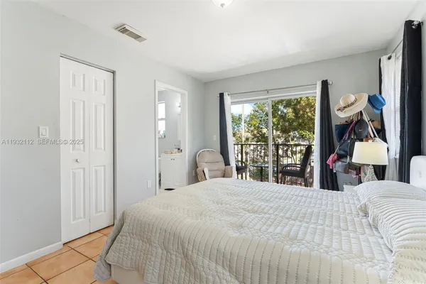 a bedroom with a large bed and a window